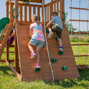 View A complete set of wooden mountain-style swings, equipped with a colorful canvas sunshade, a wave slide, a rope swing, a net swing, and a rock wall with climbing ropes and ladders. image 3